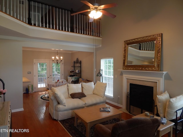 9100 Sway Branch Ln, Knoxville, TN 37922 - living room with a chandelier, wood finished floors, a fireplace with flush hearth, a ceiling fan, and a towering ceiling