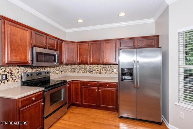 9100 Sway Branch Ln, Knoxville, TN 37922 - kitchen with stainless steel appliances, light wood-type flooring, light countertops, decorative backsplash, and crown molding