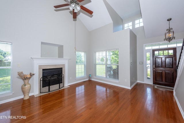 9100 Sway Branch Ln, Knoxville, TN 37922 - entryway featuring high vaulted ceiling, wood finished floors, a ceiling fan, a fireplace, and a chandelier