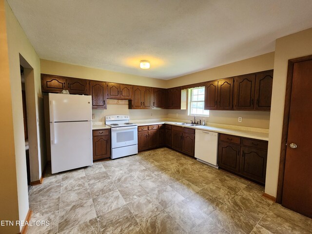232 Kimberly Rd, Lafollette, TN 37766 - kitchen with white appliances, light countertops, a sink, and dark brown cabinetry
