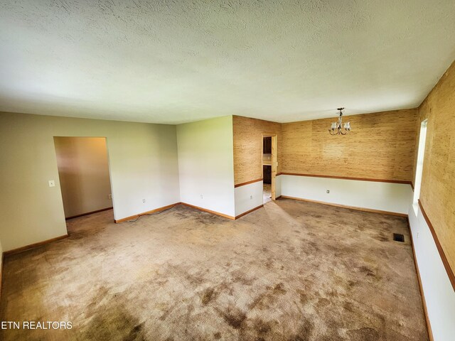 232 Kimberly Rd, Lafollette, TN 37766 - empty room with carpet floors, a chandelier, baseboards, and a textured ceiling