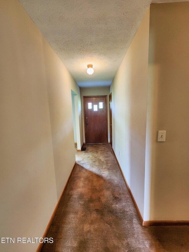 232 Kimberly Rd, Lafollette, TN 37766 - hall featuring a textured ceiling, baseboards, and carpet