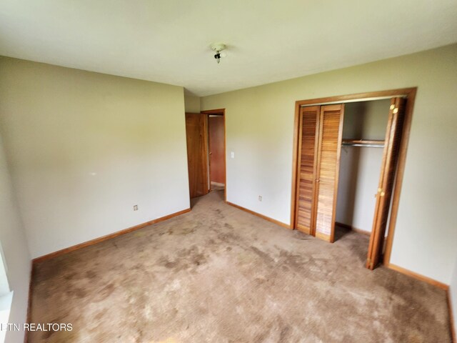232 Kimberly Rd, Lafollette, TN 37766 - unfurnished bedroom with light carpet, a closet, and baseboards