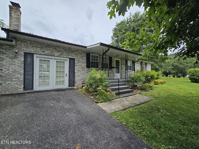 114 Verdun Rd, Oneida, TN 37841 - ranch-style house with a front lawn, brick siding, a porch, and a chimney