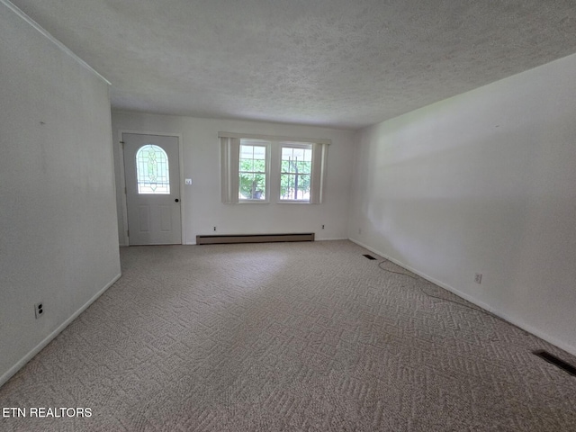 114 Verdun Rd, Oneida, TN 37841 - carpeted spare room featuring a baseboard radiator, baseboards, and a textured ceiling