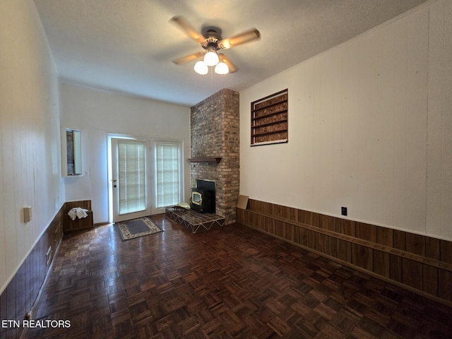 114 Verdun Rd, Oneida, TN 37841 - unfurnished living room featuring wooden walls, a ceiling fan, and a wainscoted wall