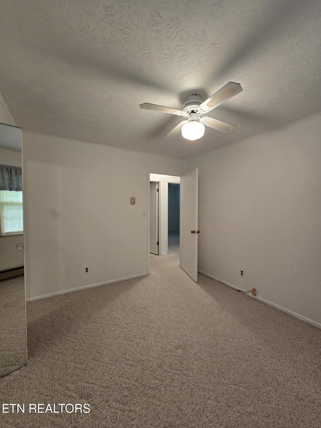 114 Verdun Rd, Oneida, TN 37841 - unfurnished room featuring light carpet, ceiling fan, baseboard heating, baseboards, and a textured ceiling