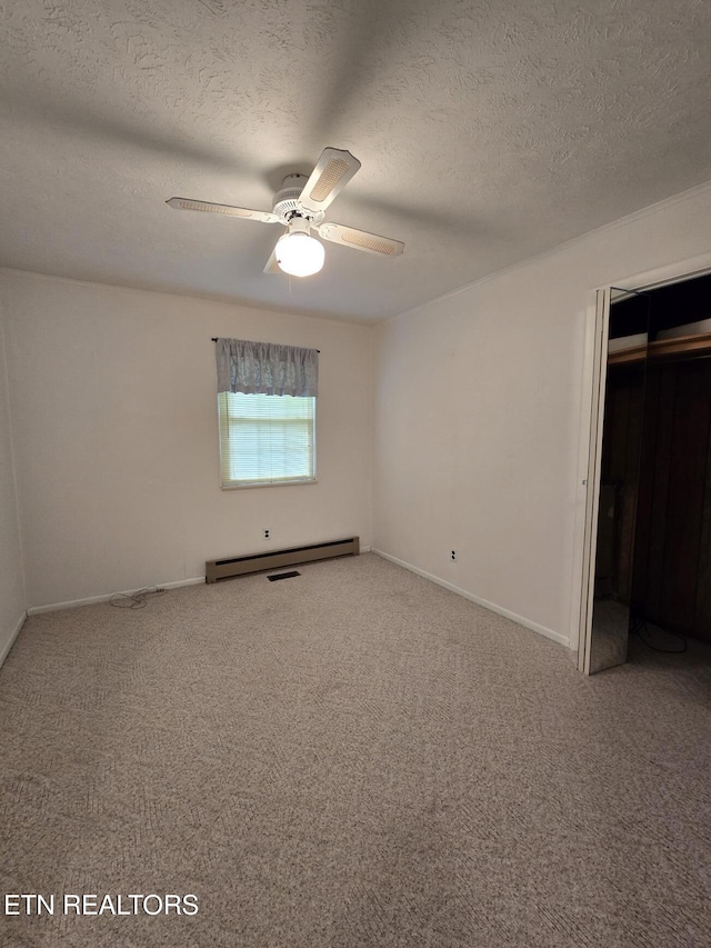 114 Verdun Rd, Oneida, TN 37841 - unfurnished bedroom featuring a baseboard heating unit, carpet flooring, a textured ceiling, baseboards, and ceiling fan