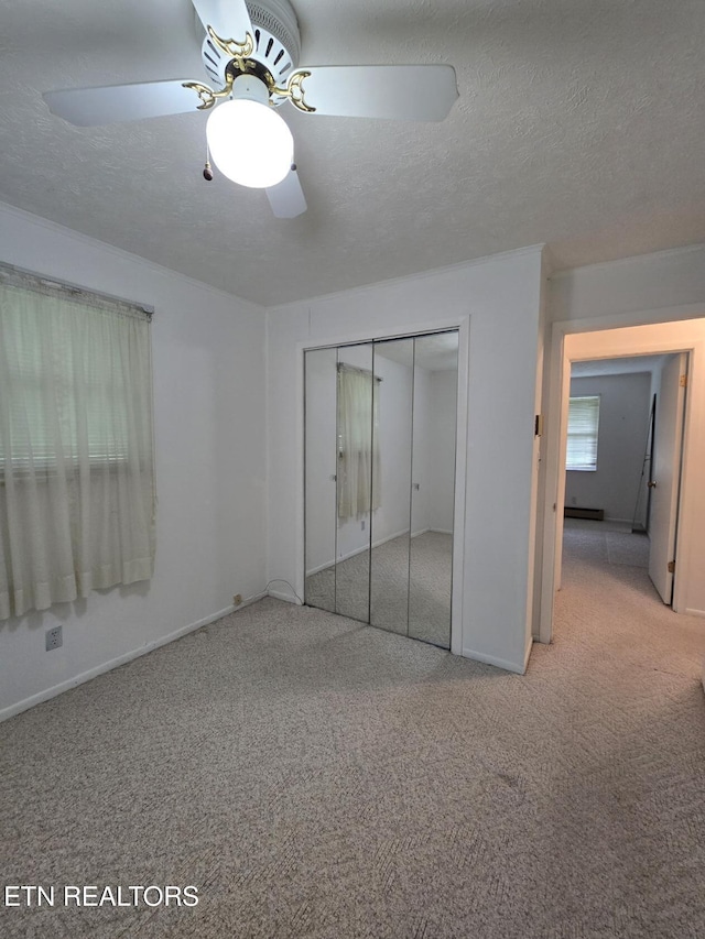 114 Verdun Rd, Oneida, TN 37841 - unfurnished bedroom featuring carpet, a closet, baseboards, ceiling fan, and a textured ceiling
