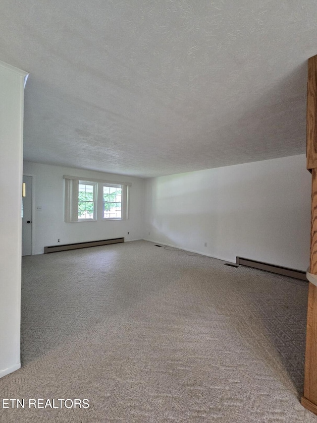 114 Verdun Rd, Oneida, TN 37841 - carpeted spare room featuring baseboard heating, a textured ceiling, and a baseboard heating unit