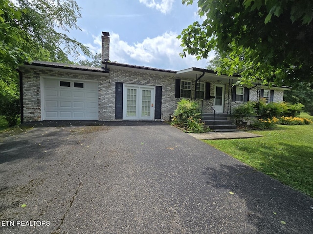 114 Verdun Rd, Oneida, TN 37841 - ranch-style house featuring an attached garage, asphalt driveway, brick siding, a chimney, and a front yard