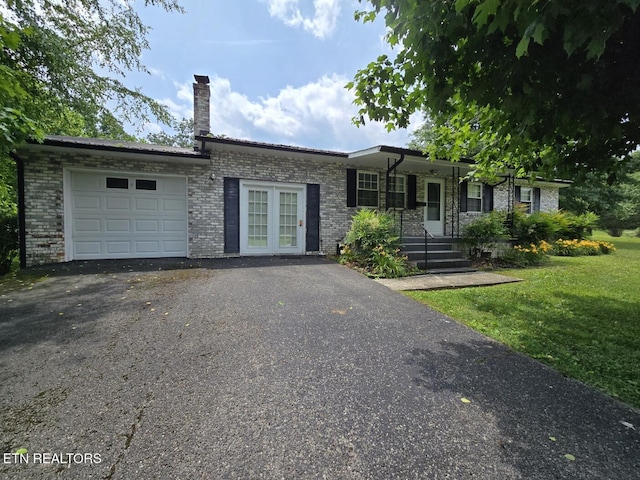 114 Verdun Rd, Oneida, TN 37841 - ranch-style house with a garage, brick siding, driveway, a front lawn, and a chimney