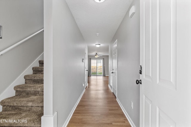 203 Bar Tall Way, Seymour, TN 37865 - corridor featuring wood finished floors, stairs, and a textured ceiling