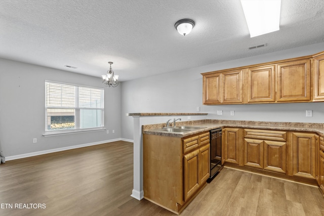 203 Bar Tall Way, Seymour, TN 37865 - kitchen featuring dishwasher, wood finished floors, a peninsula, brown cabinets, and a textured ceiling