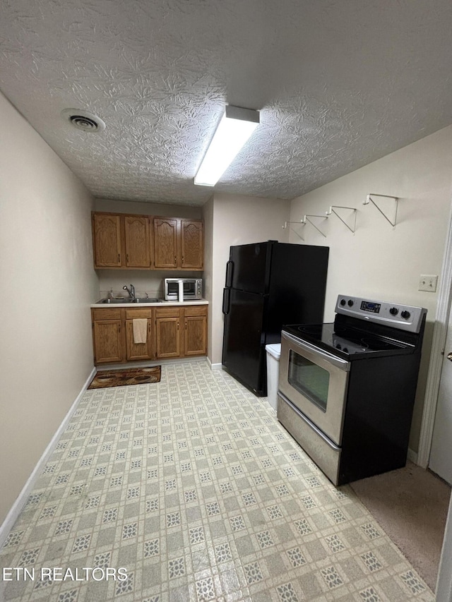 2726 Kentwood Dr, Kodak, TN 37764 - kitchen with appliances with stainless steel finishes, brown cabinets, a textured ceiling, light countertops, and baseboards