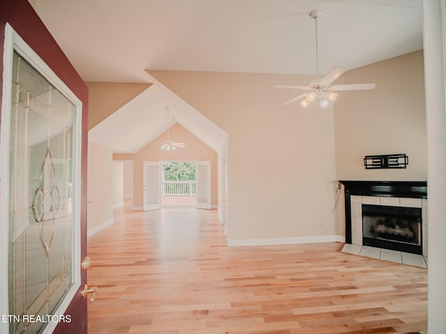 116 Deer Path Trl, Vonore, TN 37885 - unfurnished living room featuring ceiling fan, wood finished floors, lofted ceiling, a tiled fireplace, and baseboards