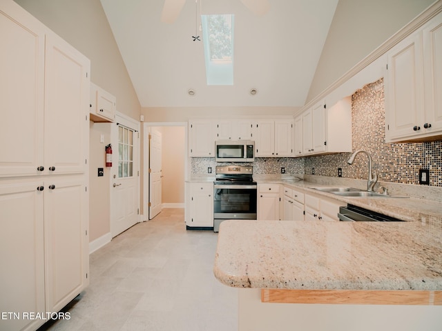116 Deer Path Trl, Vonore, TN 37885 - kitchen featuring appliances with stainless steel finishes, lofted ceiling, a sink, backsplash, and light stone counters