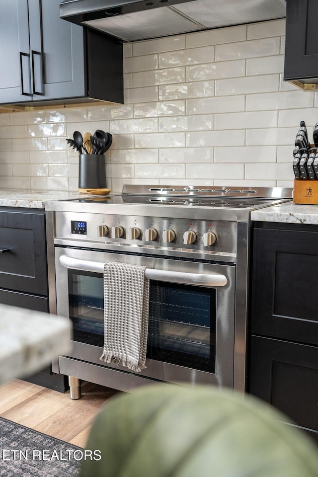 2634 Whipoorwill Hill Way, Sevierville, TN 37862 - kitchen with stainless steel electric range, backsplash, and exhaust hood