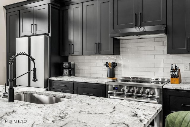 2634 Whipoorwill Hill Way, Sevierville, TN 37862 - kitchen featuring under cabinet range hood, decorative backsplash, stainless steel appliances, and dark cabinetry