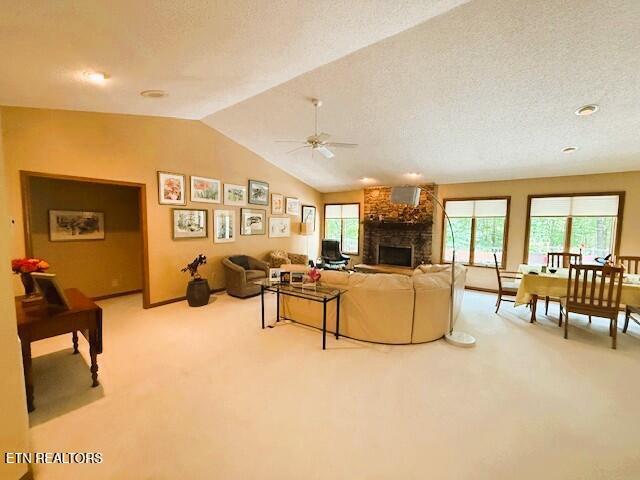 128 Cathedral Dr, Crossville, TN 38558 - living room featuring light carpet, a ceiling fan, a fireplace, and lofted ceiling