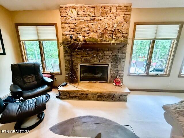 128 Cathedral Dr, Crossville, TN 38558 - carpeted living area with a stone fireplace and plenty of natural light