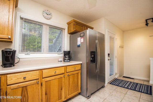 245 Doe Ln Unit 5, Lafollette, TN 37766 - kitchen featuring stainless steel fridge, light tile patterned floors, light countertops, brown cabinetry, and baseboards
