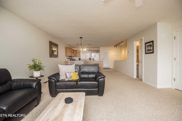 245 Doe Ln Unit 5, Lafollette, TN 37766 - living room with light carpet, a textured ceiling, baseboards, and a chandelier