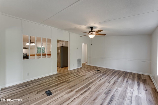 135 Mt View Rd, Sweetwater, TN 37874 - unfurnished living room featuring wood finished floors, a ceiling fan, and a chandelier