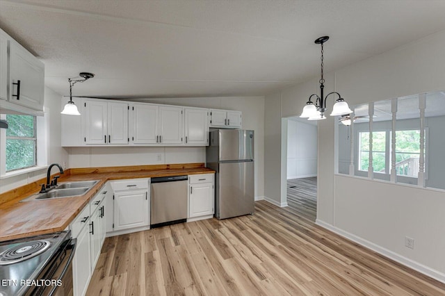 135 Mt View Rd, Sweetwater, TN 37874 - kitchen featuring stainless steel appliances, wooden counters, light wood-style flooring, white cabinets, and vaulted ceiling