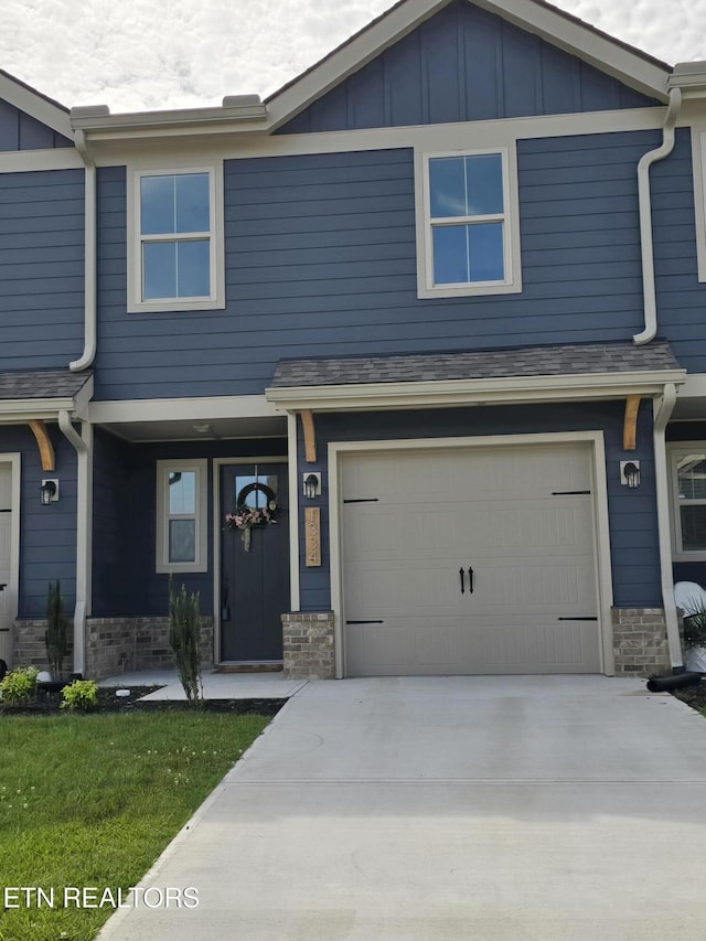 1334 Mountain Quail Cir, Maryville, TN 37801 - view of front of house featuring a garage, driveway, board and batten siding, and stone siding