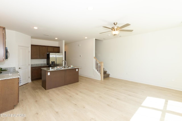 1334 Mountain Quail Cir, Maryville, TN 37801 - kitchen with appliances with stainless steel finishes, a center island with sink, light wood-type flooring, open floor plan, and recessed lighting