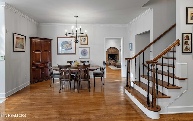 8940 Kelsey Ln, Knoxville, TN 37922 - dining room with wood finished floors, stairs, a chandelier, and ornamental molding