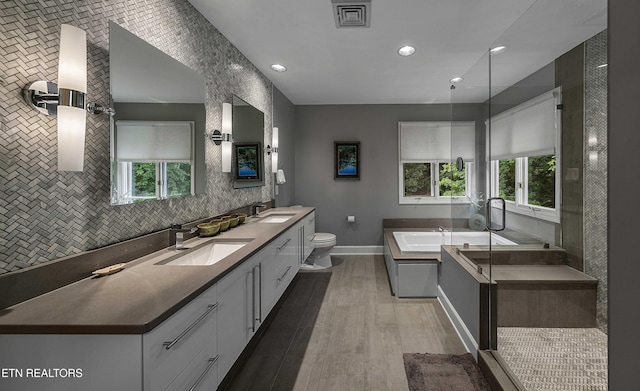 8940 Kelsey Ln, Knoxville, TN 37922 - full bathroom with wood finished floors, healthy amount of natural light, a garden tub, double vanity, and recessed lighting
