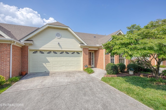 674 Applegate Ln Unit 32, Knoxville, TN 37934 - view of front of house featuring brick siding, driveway, a garage, and roof with shingles
