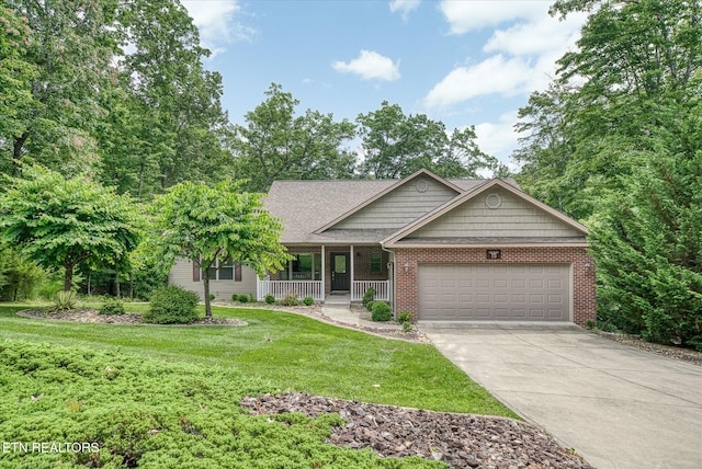 15 Chatham Ct, Fairfield Glade, TN 38558 - view of front facade with covered porch, a garage, a front yard, concrete driveway, and brick siding