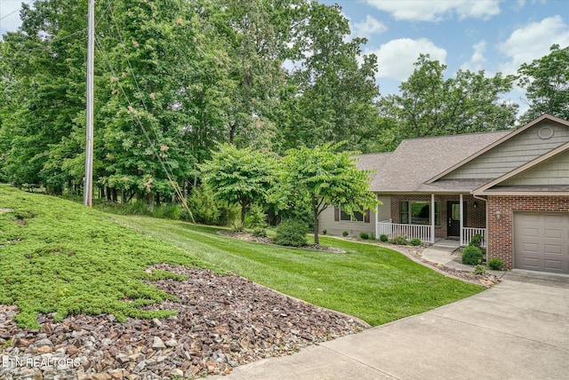 15 Chatham Ct, Fairfield Glade, TN 38558 - view of front of house featuring a porch, brick siding, a front lawn, concrete driveway, and roof with shingles