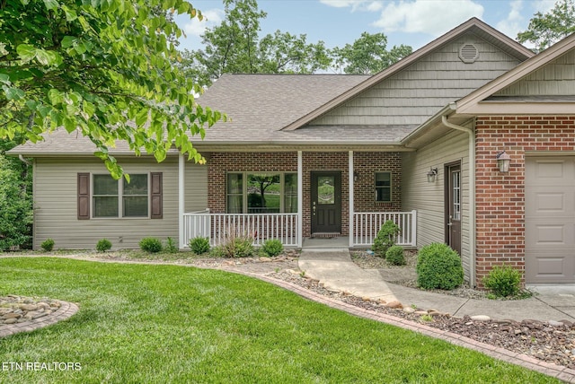 15 Chatham Ct, Fairfield Glade, TN 38558 - view of front of property featuring covered porch, a front lawn, brick siding, a shingled roof, and a garage