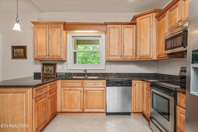 15 Chatham Ct, Fairfield Glade, TN 38558 - kitchen with appliances with stainless steel finishes, a peninsula, light tile patterned floors, pendant lighting, and dark stone countertops