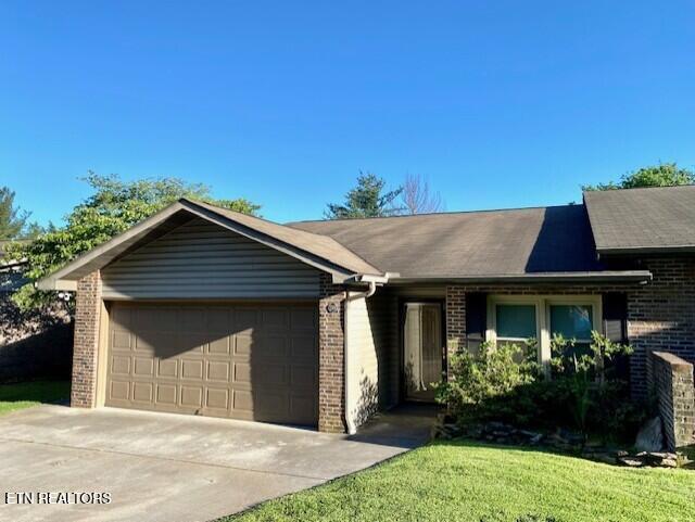 219 Villa Dr, Seymour, TN 37865 - single story home with brick siding, a garage, driveway, and a front yard