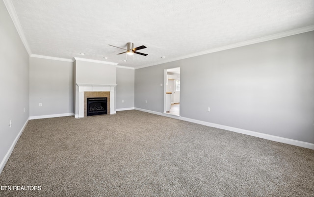 165 Kenzie Ln, Lafollette, TN 37766 - unfurnished living room with a ceiling fan, a tiled fireplace, ornamental molding, and carpet flooring