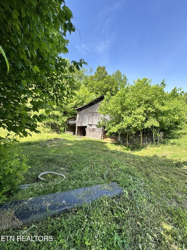 2395 Howard Rd, Bybee, TN 37713 - view of grassy yard with a barn and an outbuilding