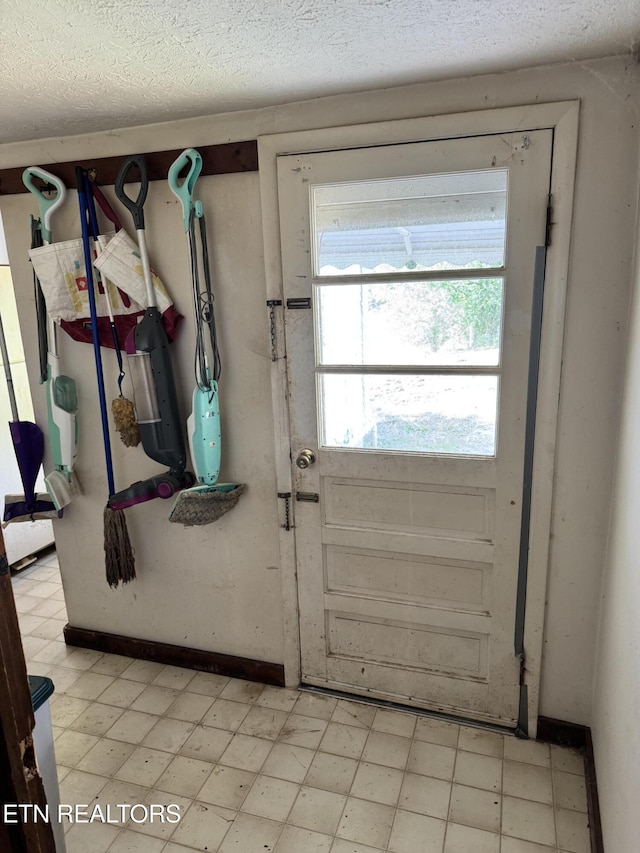 2395 Howard Rd, Bybee, TN 37713 - doorway featuring light floors, a textured ceiling, and baseboards