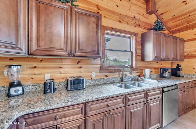 3708 Tilda Hilltop Way, Sevierville, TN 37862 - kitchen with stainless steel dishwasher, a sink, wooden walls, lofted ceiling, and light stone counters