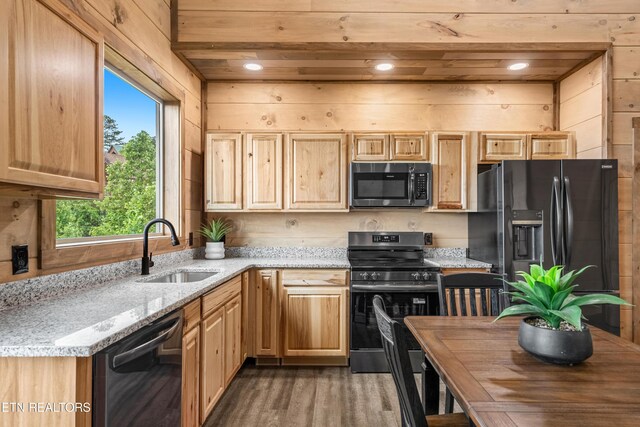 2251 Fox Berry Way, Sevierville, TN 37876 - kitchen featuring black appliances, wood finished floors, light brown cabinetry, and light stone counters