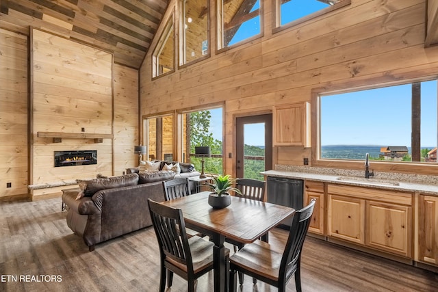 2251 Fox Berry Way, Sevierville, TN 37876 - dining room with wood walls, high vaulted ceiling, dark wood-style floors, wooden ceiling, and a warm lit fireplace