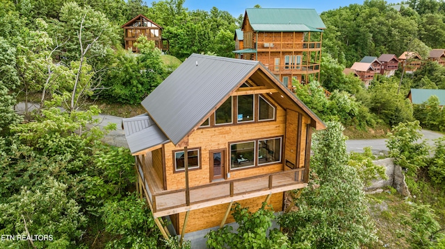 2251 Fox Berry Way, Sevierville, TN 37876 - back of house with a balcony, a metal roof, and view of scattered trees