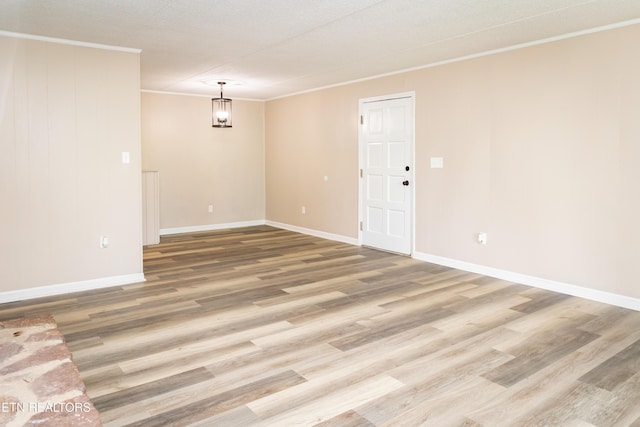 3815 E E Pkwy Apt 13, Gatlinburg, TN 37738 - spare room featuring ornamental molding, light wood-style floors, and baseboards