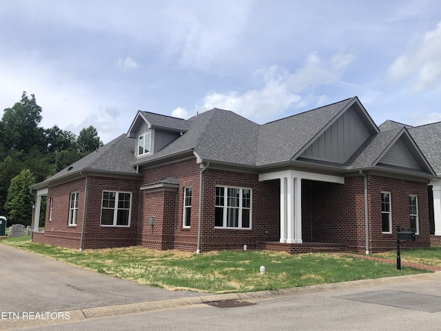 85 Royal Troon Cir, Oak Ridge, TN 37830 - view of front of home featuring brick siding, board and batten siding, a shingled roof, and a front yard