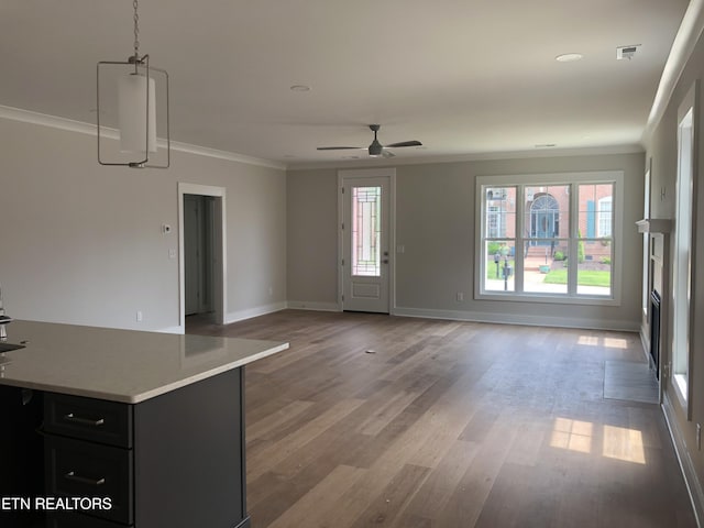 85 Royal Troon Cir, Oak Ridge, TN 37830 - unfurnished living room with crown molding, healthy amount of natural light, a ceiling fan, and light wood-style flooring