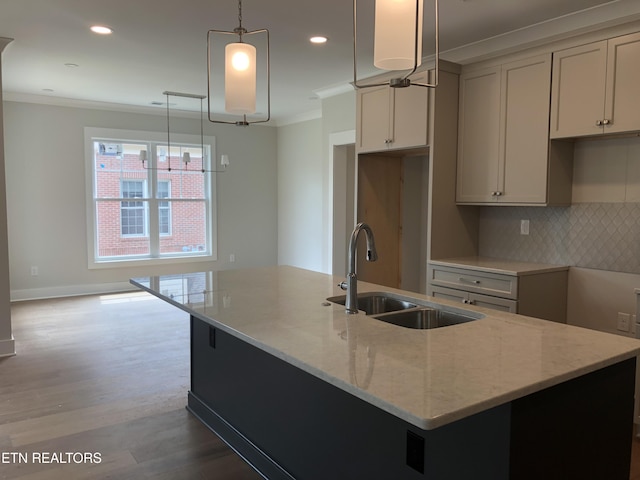 85 Royal Troon Cir, Oak Ridge, TN 37830 - kitchen featuring ornamental molding, a center island with sink, decorative backsplash, wood finished floors, and light stone countertops